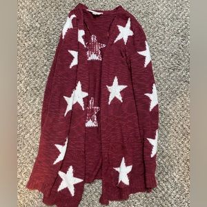 Red cardigan with white stars.